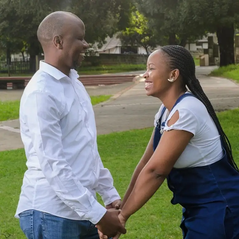 Une couple dans la trentaine sourit largement.