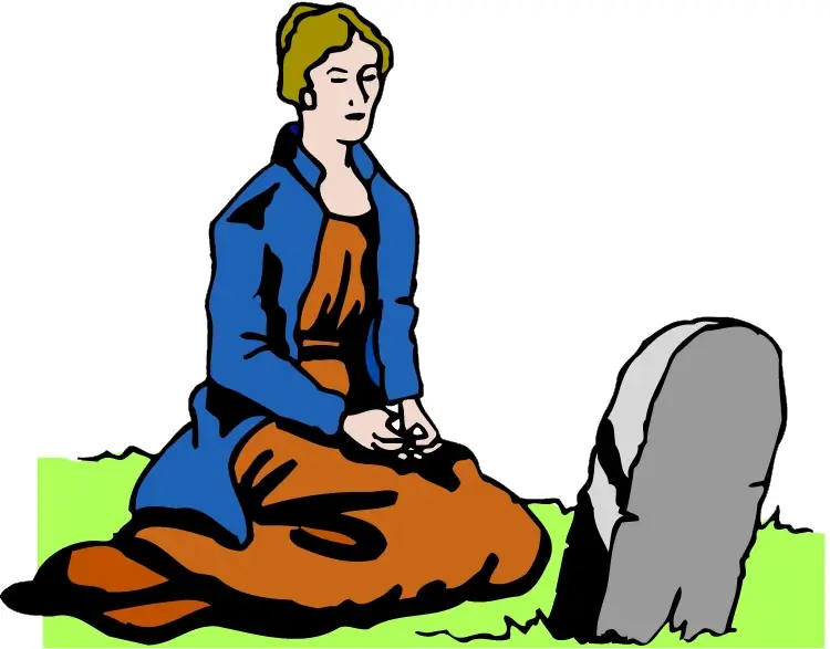 Une dame à genou devant une pierre tombale
