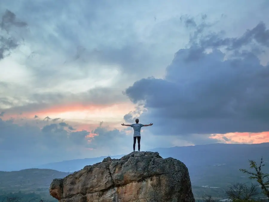 Un homme debout au sommet d’une montagne